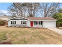 Charming home with a red front door and freshly landscaped front yard at 1206 Dubose St, Garner, NC 27529