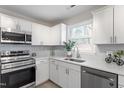 Modern kitchen showcasing stainless steel appliances, and bright white cabinets at 1206 Dubose St, Garner, NC 27529