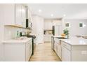 Well-lit kitchen with ample cabinet space, stainless steel appliances, and a stylish island sink at 121 Sacred Fire Rd, Louisburg, NC 27549