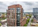 Brick exterior of a modern high-rise building with expansive windows, offering urban living at its finest at 122 N Harrington St # 1105, Raleigh, NC 27603