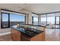 Gourmet kitchen showcasing granite countertops, stainless steel sink, and an open view to the living area at 122 N Harrington St # 1105, Raleigh, NC 27603