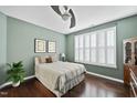 Comfortable bedroom with hardwood floors, plantation shutters, and neutral decor at 1319 Rodessa Run, Raleigh, NC 27607