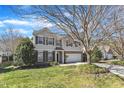 Two-story home featuring a well-manicured lawn and an attached two-car garage on a sunny day at 2224 Cedar Grove Dr, Durham, NC 27703