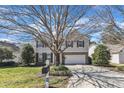Two-story home featuring a well-manicured lawn and an attached two-car garage on a sunny day at 2224 Cedar Grove Dr, Durham, NC 27703