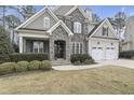 Charming two-story home with a stone facade, a two-car garage, and manicured lawn at 2401 Chianti Ct, Apex, NC 27502