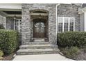 Elegant stone entryway with double doors and decorative wreaths at 2401 Chianti Ct, Apex, NC 27502