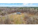 High angle view of the house nestled within a serene and wooded landscape at 2418 Crossroads Ave, Hillsborough, NC 27278