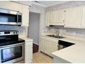 Well-lit kitchen featuring stainless steel appliances, tile floor, and neutral countertops at 250 S Estes S Dr # Apt 113, Chapel Hill, NC 27514