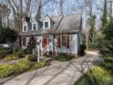 Charming two-story home with dormer windows, red shutters and professional landscaping at 2512 Winterbury Ct, Raleigh, NC 27607