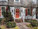 Inviting entrance featuring a red front door, sidelights, and brick walkway at 2512 Winterbury Ct, Raleigh, NC 27607