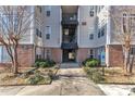 Apartment entryway featuring access stairs, secure doors, and accessible parking, ensuring a welcoming arrival experience at 2520 Friedland Pl # 102, Raleigh, NC 27617