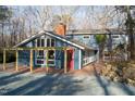 Beautiful home with a pergola-covered porch, brick pathway and red door, offering charm and curb appeal at 2819 Meacham Rd, Chapel Hill, NC 27516