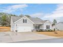 New construction with a two-car garage, covered entrance, and neutral colored siding and dark trim at 295 Barbour Farm Ln, Four Oaks, NC 27524