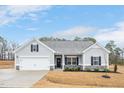 Charming single-story home features a two-car garage, gray siding, and a welcoming front porch at 295 Barbour Farm Ln, Four Oaks, NC 27524