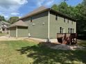 Expansive backyard with a well-maintained lawn and a cozy deck for outdoor relaxation at 3005 Domaine Dr, Wake Forest, NC 27587