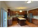 Spacious kitchen with a functional island, granite countertops, stainless steel appliances, and sleek cabinetry at 3032 Kilarney Ridge Loop, Cary, NC 27511