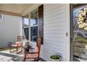 Inviting front porch features rocking chairs, a decorative wreath, and a view of the home's charming exterior at 305 Chestnut Oaks Pl, Durham, NC 27704