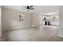 Open-concept living area with light wood flooring and a modern ceiling fan at 312 W Union St, Hillsborough, NC 27278
