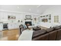 Beautiful living room with a fireplace, built-in shelving, and hardwood floors, perfect for entertaining at 400 Edinburgh Dr, Cary, NC 27511