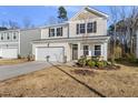 Charming two-story home featuring a two-car garage and manicured front yard at 449 Willard Woods Dr, Wendell, NC 27591