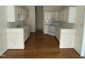Spacious kitchen featuring white cabinets and hardwood floors at 4909 Willow Tree Ln, Clayton, NC 27520