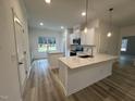 Modern kitchen featuring white cabinetry, stainless steel appliances, and a spacious center island at 5004 Macleod Pl, Zebulon, NC 27597