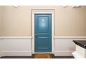 Stylish blue entry door with 'Welcome Home' mat inviting guests inside at 501 Finsbury St # 100, Durham, NC 27703