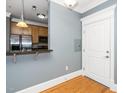 Entryway featuring hardwood floors and kitchen bar, inviting you further into the home at 501 Finsbury St # 100, Durham, NC 27703
