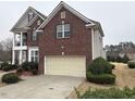 Red brick house featuring well-maintained landscaping and an attached two-car garage at 501 Liberty Rose Dr, Morrisville, NC 27560