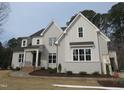 Charming two-story home featuring a gray painted brick exterior and a beautifully landscaped front yard at 505 Ansley Ridge Rdg, Cary, NC 27518