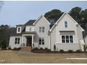 Charming two-story home featuring a gray painted brick exterior and a beautifully landscaped front yard at 505 Ansley Ridge Rdg, Cary, NC 27518