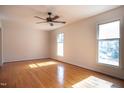 Bright and spacious bedroom with hardwood floors, neutral walls, and two windows providing natural light at 524 Farmington Woods Dr, Cary, NC 27511