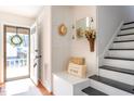 Charming foyer area with built-in bench, decorative accents, and staircase leading to the upper level at 524 Farmington Woods Dr, Cary, NC 27511