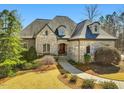 Well maintained stone home featuring a garden and manicured lawn at 601 Golfers Vw, Pittsboro, NC 27312