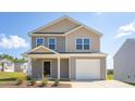 Charming two-story home with a one-car garage and manicured lawn against a bright blue sky at 6048 Sodium St, Raleigh, NC 27610