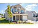 Charming two-story home with a one-car garage and manicured lawn against a bright blue sky at 6048 Sodium St, Raleigh, NC 27610