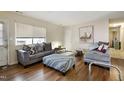 Bright living room with hardwood floors, comfortable seating, and natural light from large windows at 618 White St, Selma, NC 27576