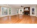 Bright living room with hardwood floors, fireplace, and large windows with natural light at 6800 Chamonix Pl, Raleigh, NC 27613