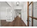Elegant foyer with hardwood floors, white trim, and natural light at 9004 Penny Rd, Raleigh, NC 27606
