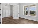 Bright office space with white walls, wainscoting, large windows, and hardwood floors creating a modern aesthetic at 9004 Penny Rd, Raleigh, NC 27606