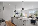 Bright kitchen featuring a center island with a sink and pendant lighting, seamlessly connecting to the dining and living areas at 1006 Westerland Way # 198, Durham, NC 27703