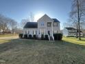 Traditional two-story house on a sunny lot with landscaped yard and inviting curb appeal at 101 Feezor Ct, Clayton, NC 27527