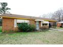 Charming brick home with covered carport and mature landscaping at 10125 Buffalo Rd, Clayton, NC 27527