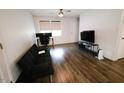 Cozy living room featuring sleek, wood-look flooring and ample natural light at 10125 Buffalo Rd, Clayton, NC 27527