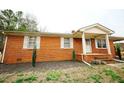 Charming brick home featuring a covered porch on a well-maintained lot at 10166 Buffalo Rd, Clayton, NC 27527