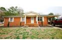 Charming brick home featuring a covered porch and carport on a well-maintained lot at 10166 Buffalo Rd, Clayton, NC 27527