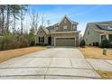 Charming two-story home featuring stone accents, a well-manicured lawn, and a spacious driveway at 137 Fawnwood Acres Dr, Apex, NC 27539