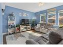 Comfortable living room features a ceiling fan, natural lighting, and neutral-colored sofas at 138 Daneborg Rd, Durham, NC 27703