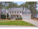 Traditional two-story house features a columned porch and attached two-car garage at 1609 Marshall Farm St, Wake Forest, NC 27587