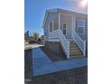 Close-up of the home's front porch with white railings and wood steps, adding curb appeal at 209 King St, Oxford, NC 27565